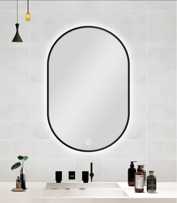 Oval LED mirror with black frame installed in Berwick bathroom