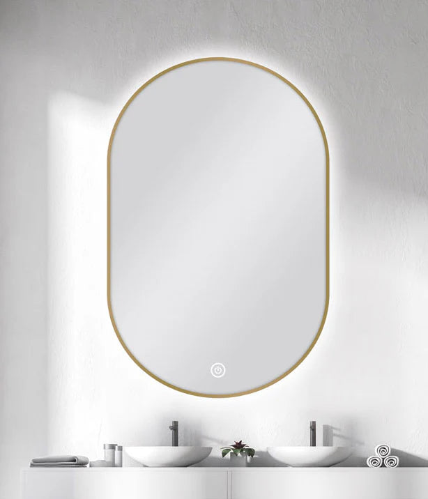 Modern oval mirror with gold frame installed in Berwick bathroom